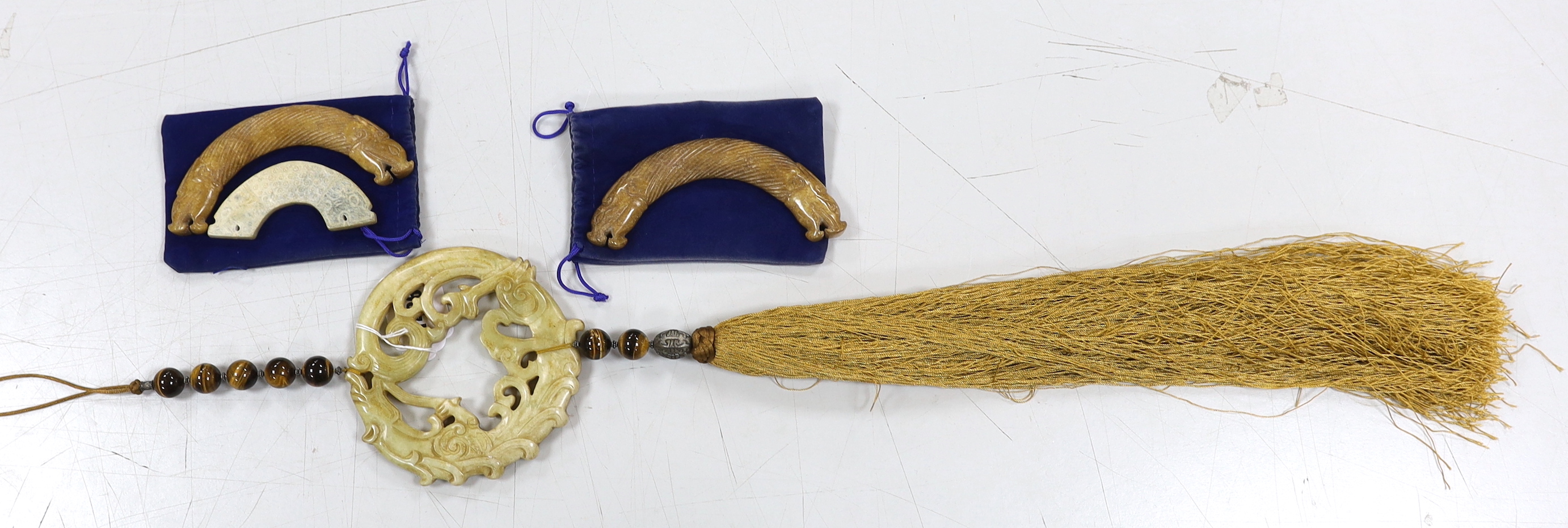 Three Chinese jade carvings, two huang, a large hardstone pendant and disc, largest overall 90cm in length (4)